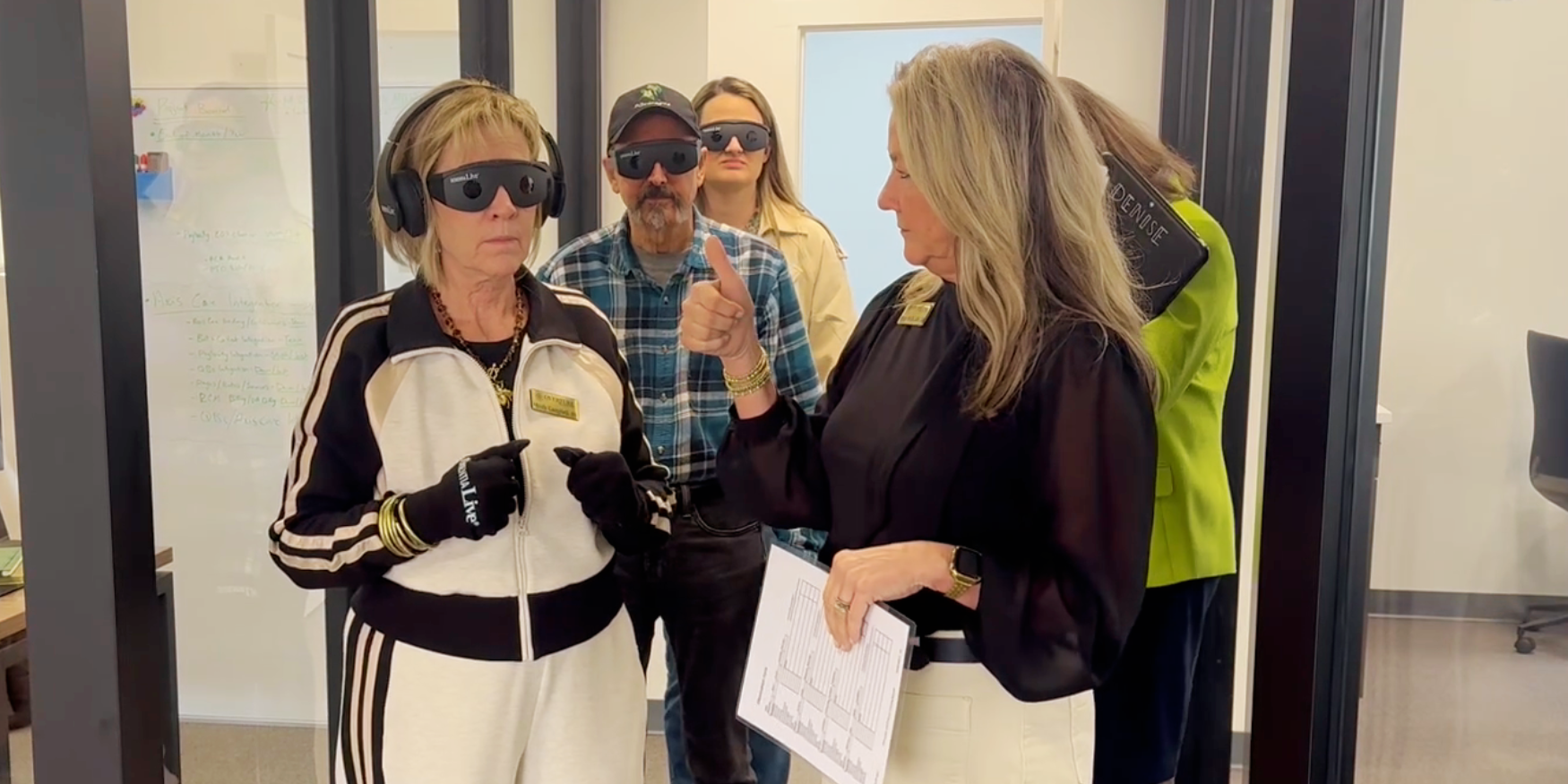 Facilitator guiding participants during a Dementia Live® experiential training, helping caregivers understand the sensory and cognitive challenges of living with dementia.