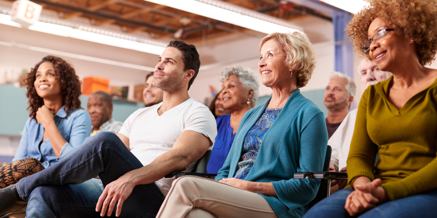 Diverse group of adults participating in a community dementia education session focused on understanding and empathy.